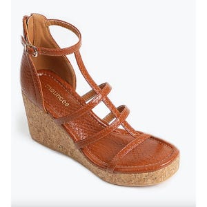 Brown strappy wedge sandal with a cork heel.