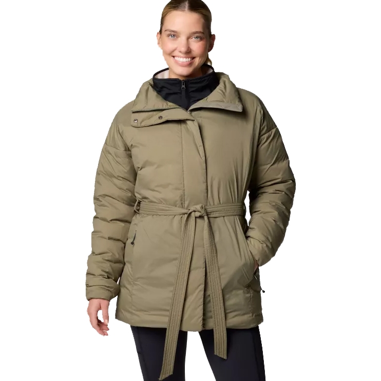 A woman wears a Columbia Belted Down Jacket in olive green, featuring a belted waist, asymmetrical zipper, and quilted design. The collar is high, and the jacket includes full-length sleeves and zippered side pockets.