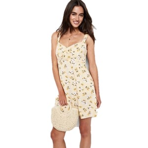 Yellow floral cami mini dress with adjustable straps, fitted bodice, and flared skirt, paired with a round straw handbag.