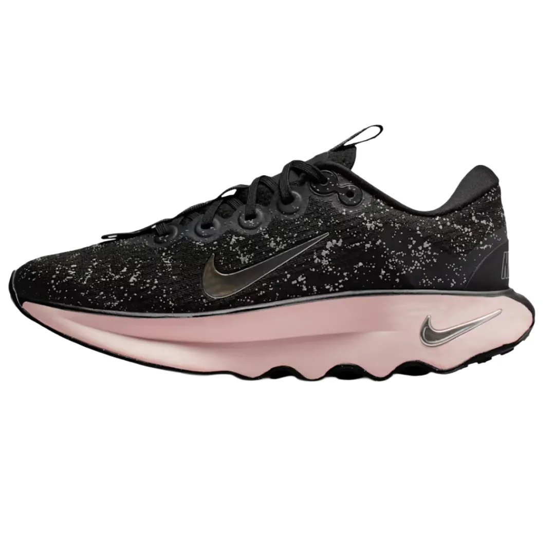 A black athletic shoe with speckled details, featuring a reflective Nike swoosh and a light pink sole.