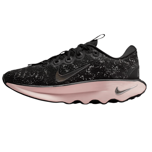 A black athletic shoe with speckled details, featuring a reflective Nike swoosh and a light pink sole.