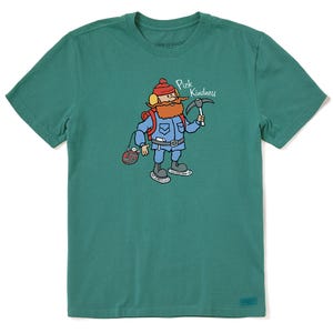Green t-shirt featuring a cartoon character wearing winter gear, holding a pickaxe with the phrase \“Pick Kindness\“ above.