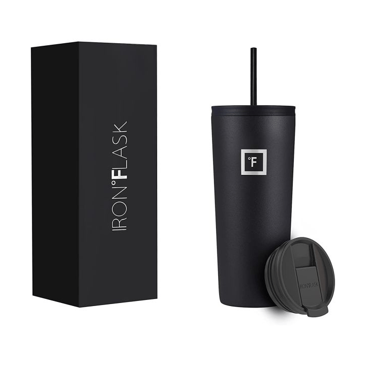 A black Iron Flask tumbler with a matching straw and an interchangeable lid is shown next to its packaging box.