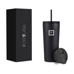 A black Iron Flask tumbler with a matching straw and an interchangeable lid is shown next to its packaging box.