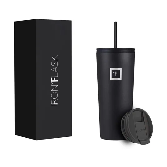 A black Iron Flask tumbler with a matching straw and an interchangeable lid is shown next to its packaging box.