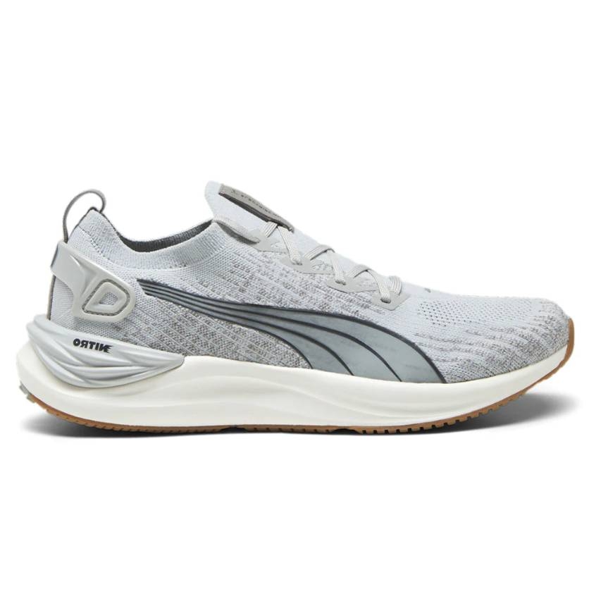 A gray Puma athletic sneaker featuring a knitted upper, prominent side branding, cushioning sole, and rubber outsole for traction.