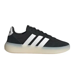 Black Adidas sneakers with white stripes and a semi-translucent sole.
