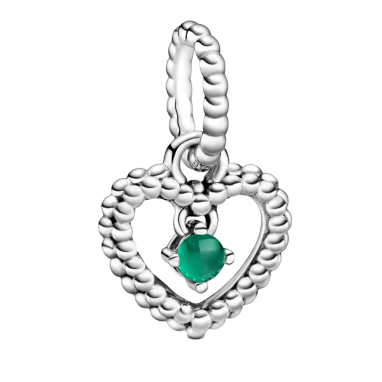 A silver heart-shaped charm with a beaded texture encloses a small green gemstone in the center.