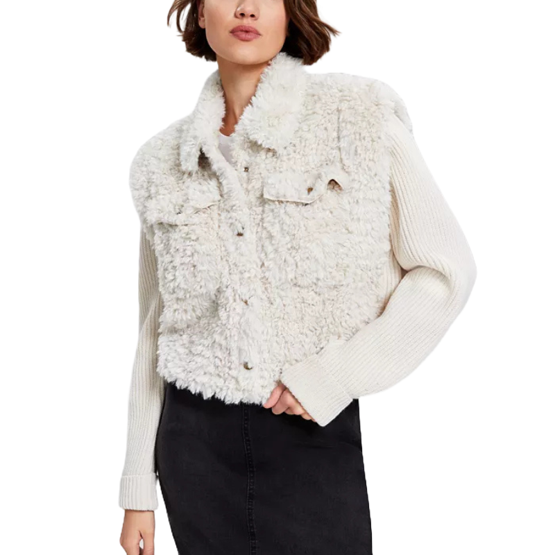 The jacket features a white sherpa body with a soft, textured appearance, and long, knitted sleeves. It has a button-up front and two chest flap pockets, offering a cozy and stylish look.