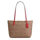 Brown Coach tote bag with red handles and accents featuring a gold Coach logo and a signature pattern.