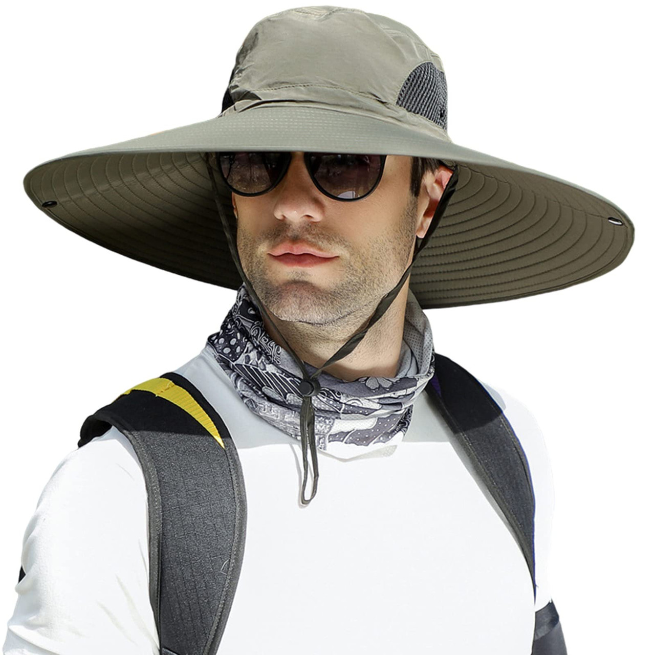 A person is wearing a wide-brimmed sun hat with chin strap, sunglasses, and a patterned neck gaiter. They have a backpack on, over a white shirt.