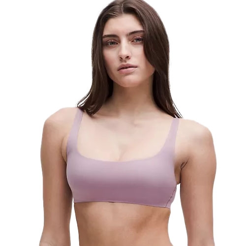 A woman wears a lavender bralette with a simple, seamless design and wide straps, providing a minimalistic and comfortable look.