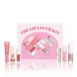 The 6pc Macy's Lip Lover Kit contains a variety of lip products in pink shades, including gloss, balm, and lipstick. The packaging features brands like Kylie and includes six different lip essentials presented in a pink-themed box.
