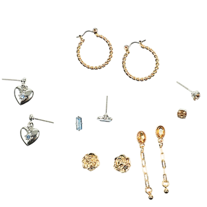 Assorted earrings include gold hoop, heart-shaped silver dangle, gold chain dangle, rose-shaped studs, and various gemstone studs.