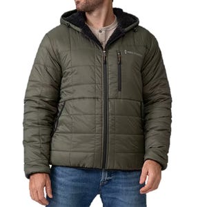 The Free Country Reversible Puffer Jacket is an olive-green, quilted, hooded jacket with a zippered front and side pockets, featuring a chest pocket and sherpa lining for added warmth.