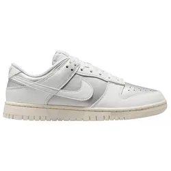 A white Nike Dunk Low sneaker with a leather upper, signature swoosh, and light beige sole.