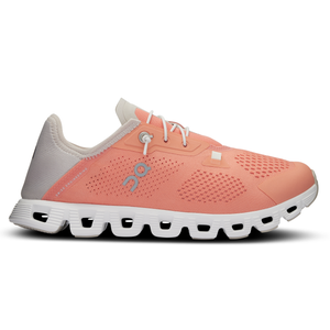 A coral and white athletic shoe featuring a breathable mesh upper, distinct air-cushioning system in the sole, and Swiss engineering design elements.