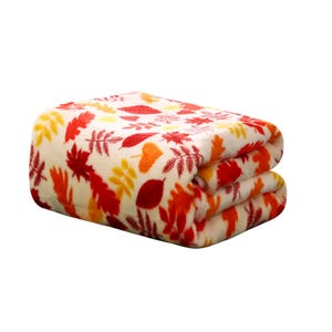 Folded fleece blanket with a yellow, orange, and red leaf pattern on a white background.