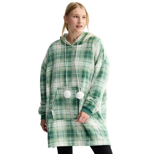 A woman is wearing an oversized hoodie with a green plaid pattern and pom-pom drawstrings.