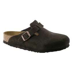 A dark brown suede clog with a cork footbed, adjustable strap, and metal buckle.