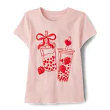 A pink short-sleeve shirt featuring a red graphic design of two strawberry-themed bubble tea cups with decorative straws.
