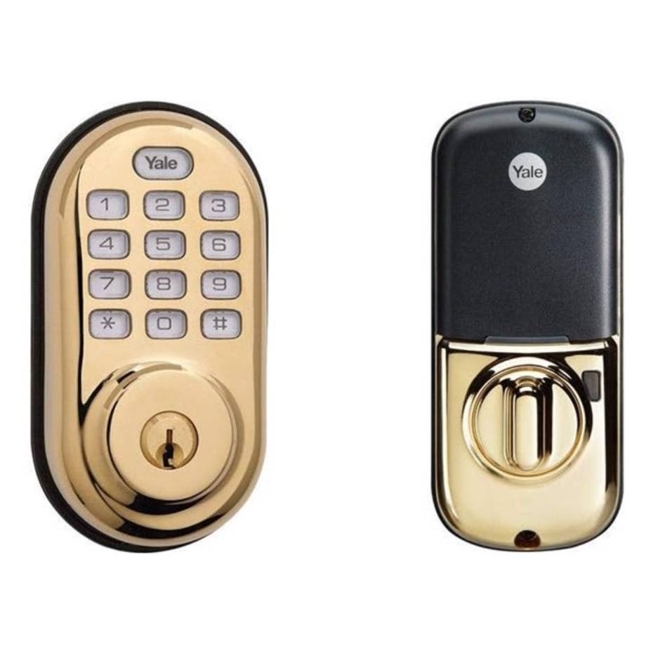 A gold-colored Yale electronic keypad lock alongside a black remote control fob.