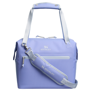 A light purple Stanley cooler bag with a handle and detachable shoulder strap. The bag features a front zippered pocket and the Stanley logo on both the bag and strap.