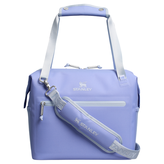 A light purple Stanley cooler bag with a handle and detachable shoulder strap. The bag features a front zippered pocket and the Stanley logo on both the bag and strap.