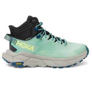 A teal and black hiking shoe with yellow HOKA branding and a Vibram sole.