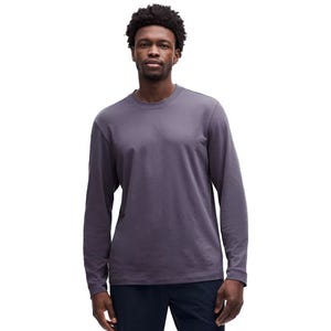 Long sleeve shirt in dark gray, featuring a simple, relaxed fit with a crew neckline, worn by a standing man.