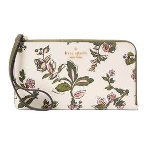 A floral-patterned Kate Spade wristlet with green and pink accents, featuring a detachable strap and gold logo detail on the front.