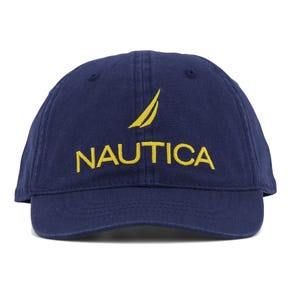 Navy blue baseball cap with \“NAUTICA\“ embroidered in yellow and a yellow sailboat logo above the text.
