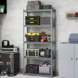 Metal shelving unit holding storage boxes, toolboxes, and power tools; surrounded by additional storage items and a cabinet.