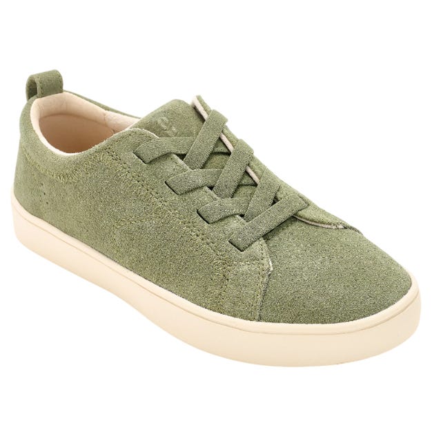 A green suede sneaker with cream-colored soles, featuring matching green laces and a pull tab at the heel.
