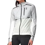 A gray and white athletic jacket with a hood and zip closure, featuring a chest pocket with the \“OC\“ logo, worn by a person with black leggings.