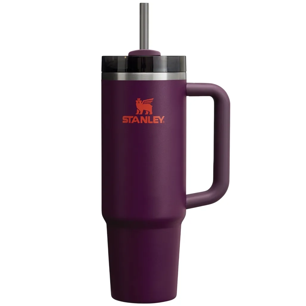 Purple Stanley tumbler with a handle, lid, and straw, featuring a logo with a winged figure.