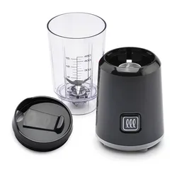A compact blender with a transparent measuring cup, blade assembly, and a black motor base with control button. Includes a black lid designed for the cup.