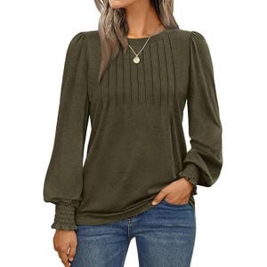 Olive green long-sleeve blouse with pleated front and smocked cuffs, paired with blue jeans.
