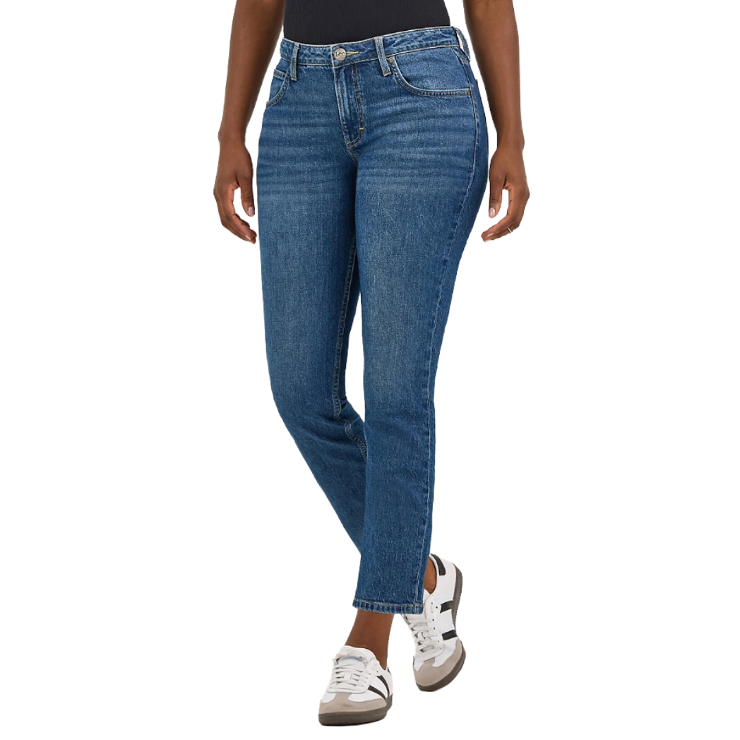 A person is wearing blue skinny jeans and white sneakers with black accents.