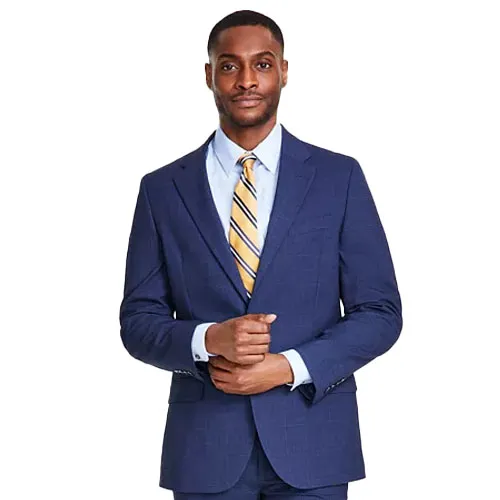 A man in a blue suit with a subtle plaid pattern, wearing a light blue dress shirt and a yellow striped tie.