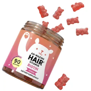 A jar of vegan gummy vitamins labeled \“Ah-Mazing Hair Vitamin\“ with biotin for hair health, featuring 90 gummies shaped like bears.