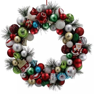 A festive wreath featuring red, green, silver, and white Christmas baubles, including a Santa figurine and a snowman, intermixed with artificial pine foliage.