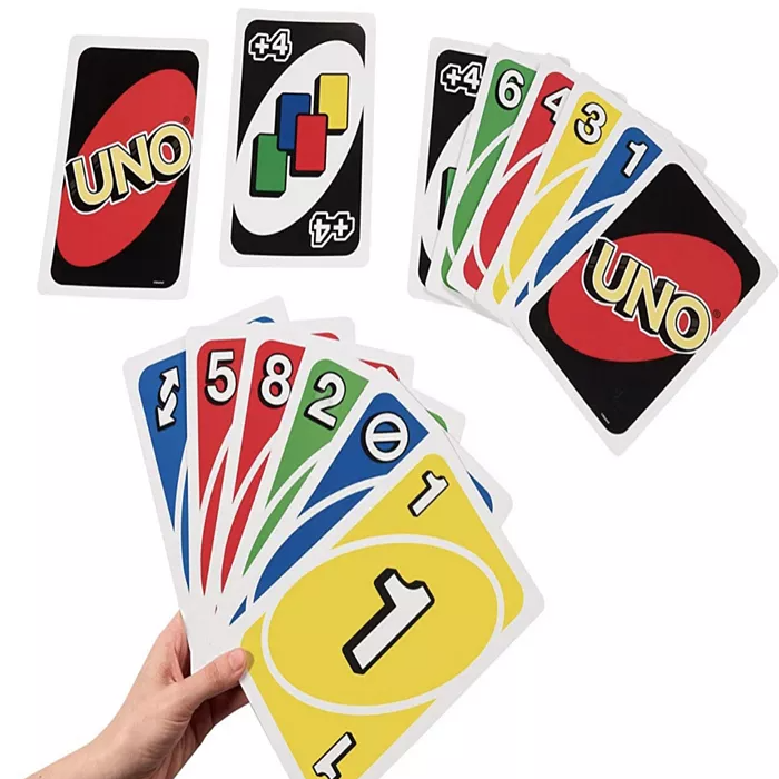 A hand holding a spread of colorful UNO playing cards, alongside separate cards showing the UNO logo and a draw four card.
