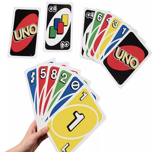 A hand holding a spread of colorful UNO playing cards, alongside separate cards showing the UNO logo and a draw four card.