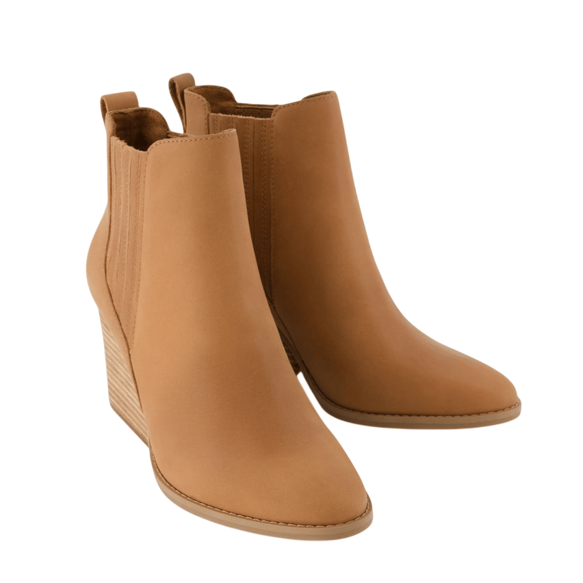 A pair of tan wedge ankle boots with a smooth finish and elastic side panels.