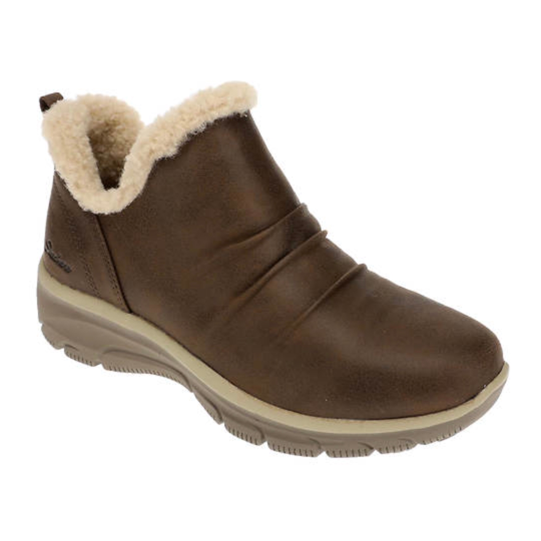 Brown ankle boot with faux-shearling lining, ruched detailing, a slip-on design, and a chunky, cushioned sole for comfort, from Skechers.
