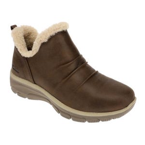 Brown ankle boot with faux-shearling lining, ruched detailing, a slip-on design, and a chunky, cushioned sole for comfort, from Skechers.