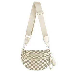 A beige and white checkered crossbody bag with a wide adjustable strap and two zippered compartments.