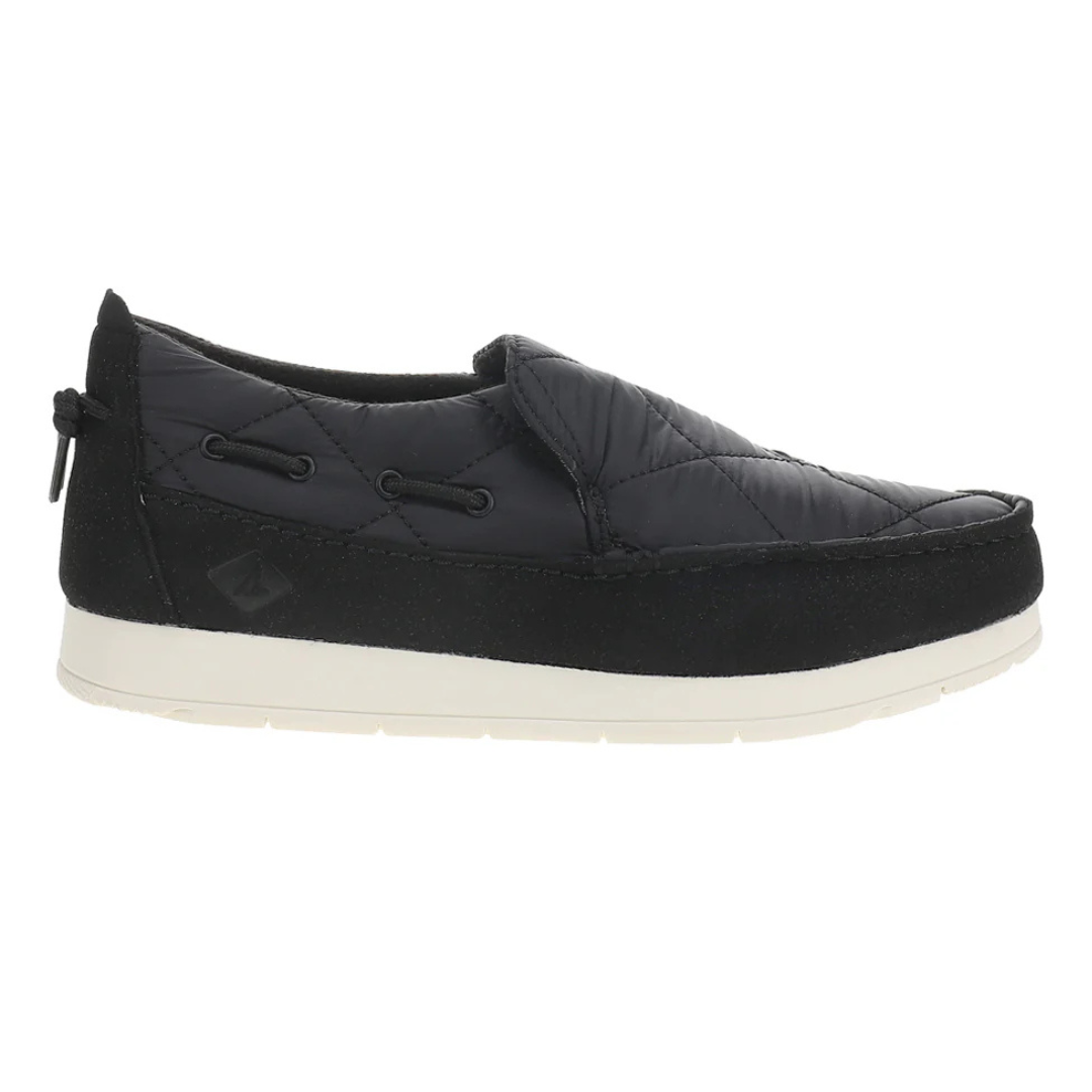 A black quilted slip-on shoe with a white sole and decorative lacing around the sides.