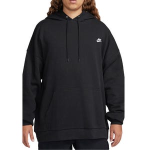 A person wears a black Nike hoodie with a small logo on the chest, featuring a front pocket and drawstring hood.